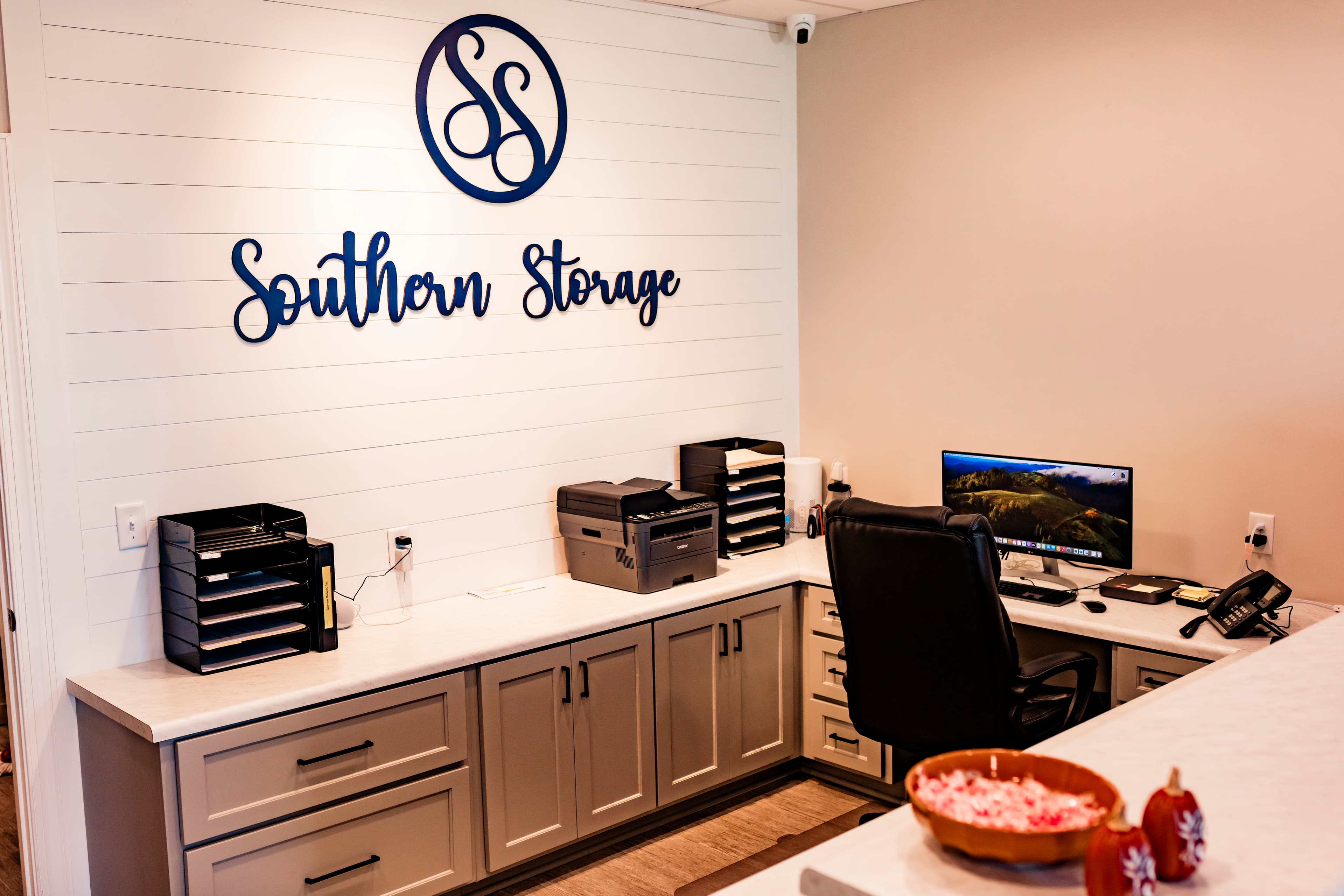 Southern Storage front office with the navy Southern Storage logo on a white shiplap wall